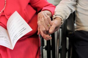 Close up on a married resident couple holding hands