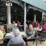 Seniors enjoy a meal alfresco on the patio