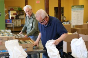 Seniors take boxed food and create Meals on Wheels packages