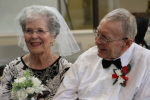 A resident couple smile while renewing their vows.