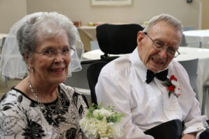 A resident couple smile while renewing their vows.