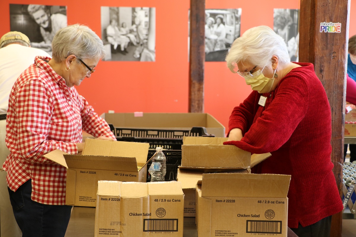 Seniors going through cardboard boxes