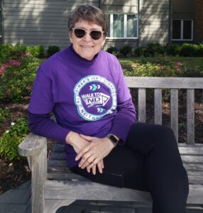 Resident Dr. Rebecca Moak sits on a park bench 