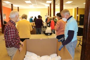 A group of seniors get donations ready for Meals on Wheels