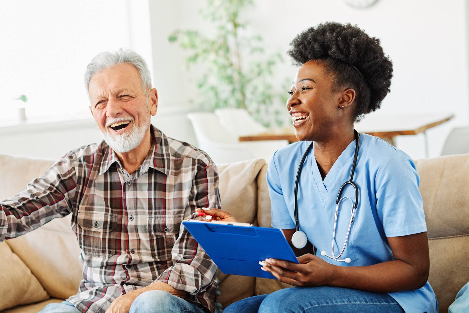 senior in long-term care talking with a health care worker