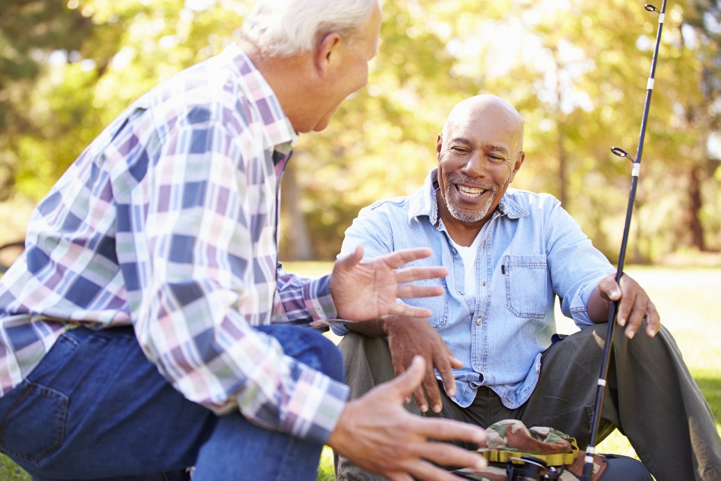 two senior men fishing in a pond