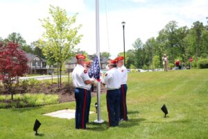 American Legion members raise American flag at the Clubhouse at Lakewood Senior Living