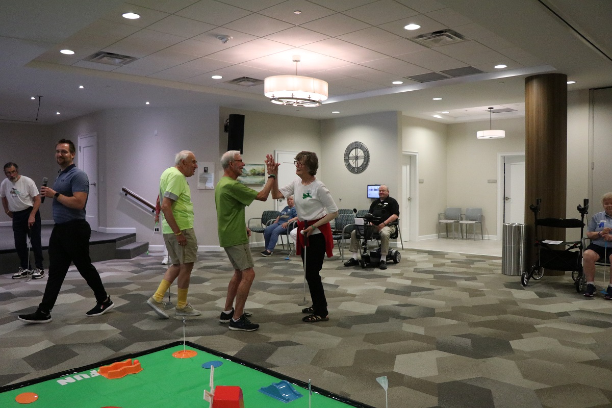 Seniors playing mini golf