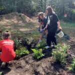 Four girl scouts volunteer to plant a garden at Lakewood