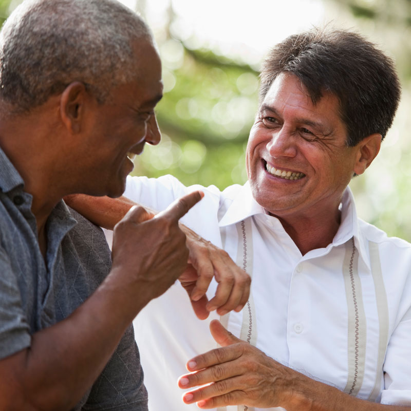 two older men laughing at senior living community