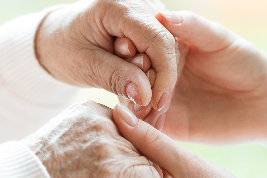 Caregiver guilt management. Daughter showing mom support as she transitions to assisted living facility.