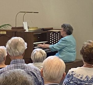 Senior woman playing the Organ at the Spiritual Music Event