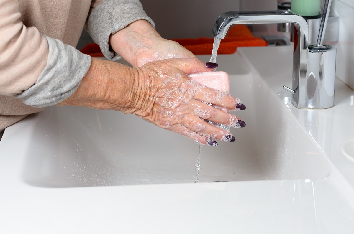 senior woman washing hands