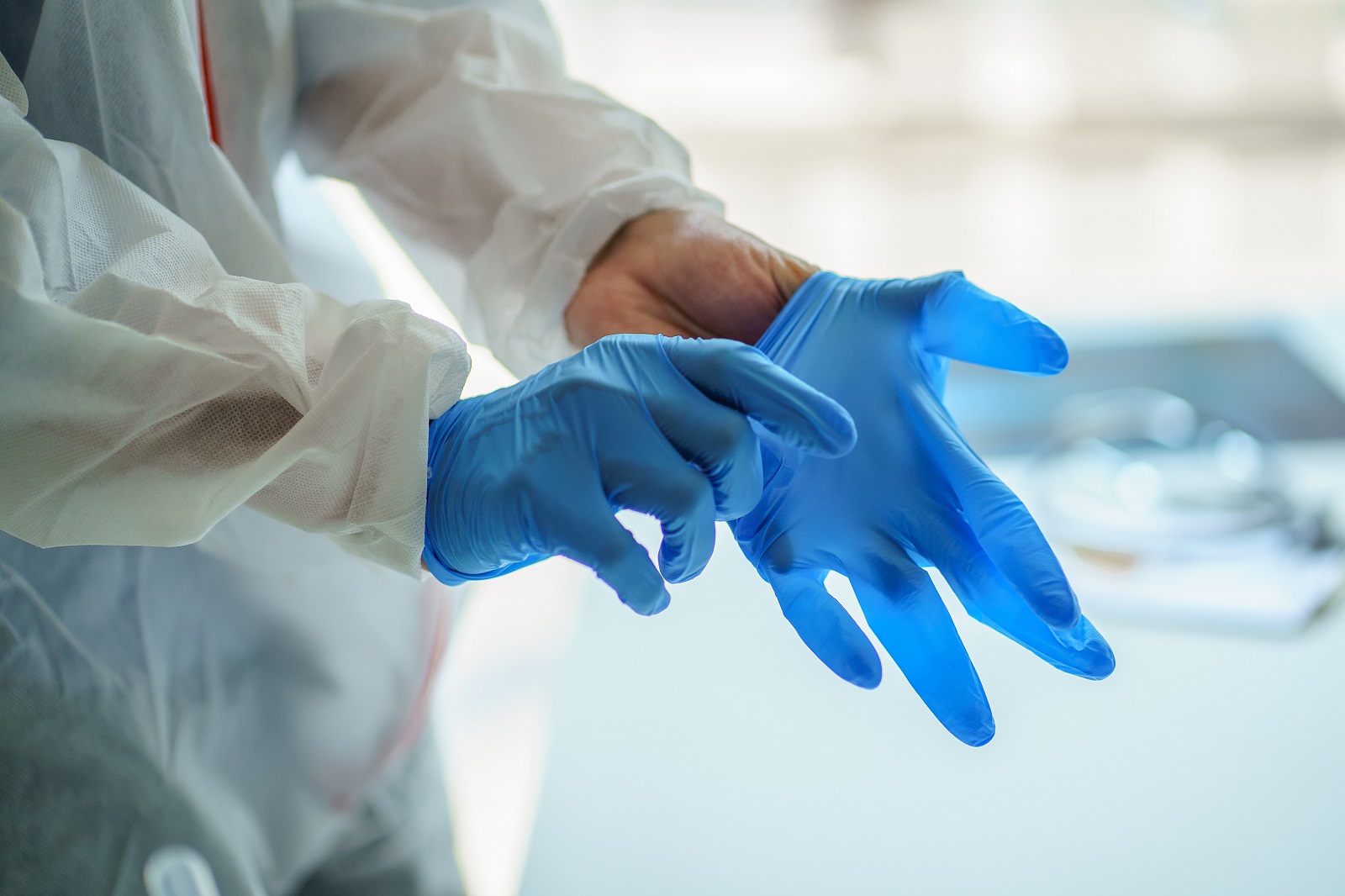 male doctor putting on medical gloves