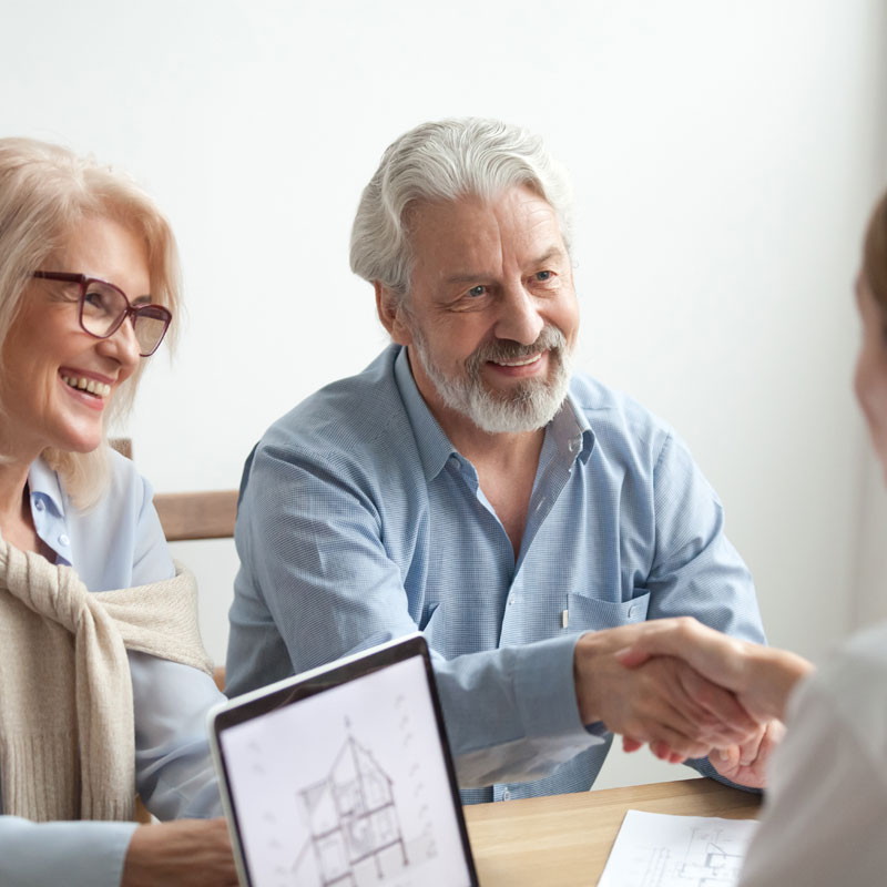 Seniors discussing floor plan options at retirement community