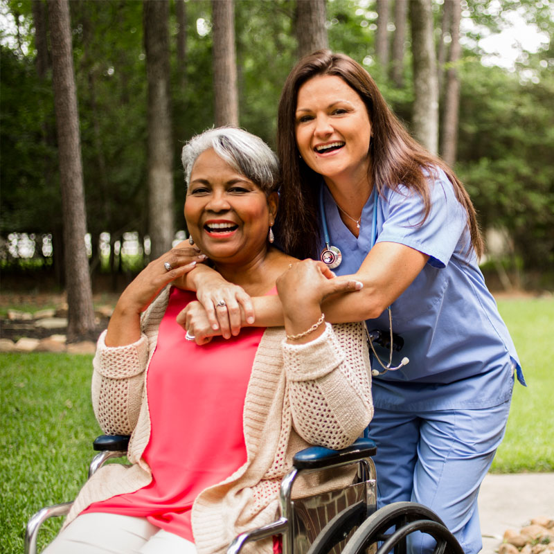 nurse giving a hug to senior female