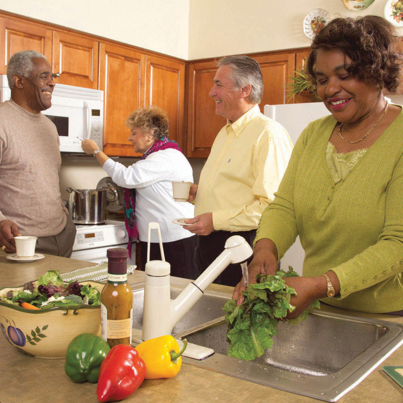 Senior couple cooking dinner in senior home kitchen